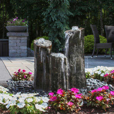 Triple Rustic Basalt Fountain Kit in action with frontage white and pink flowers
