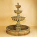 Urbino Grande Tall Three Tier Pond Fountain against brown background.