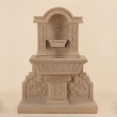 Uva Wall Fountain against brown background.