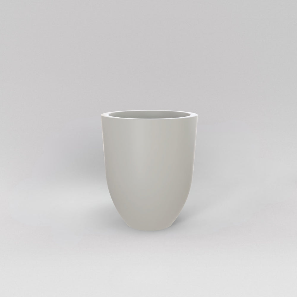 Valencia Tapered Round Fiberglass Planter in matte cement grey against gray background.