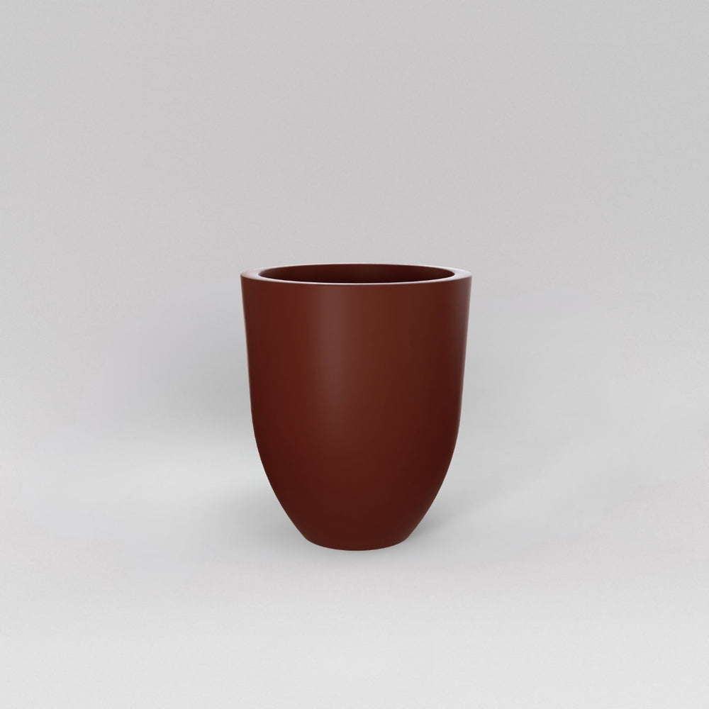 Valencia Tapered Round Fiberglass Planter in matte terra cotta against gray background.