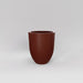 Valencia Tapered Round Fiberglass Planter in matte terra cotta against gray background.