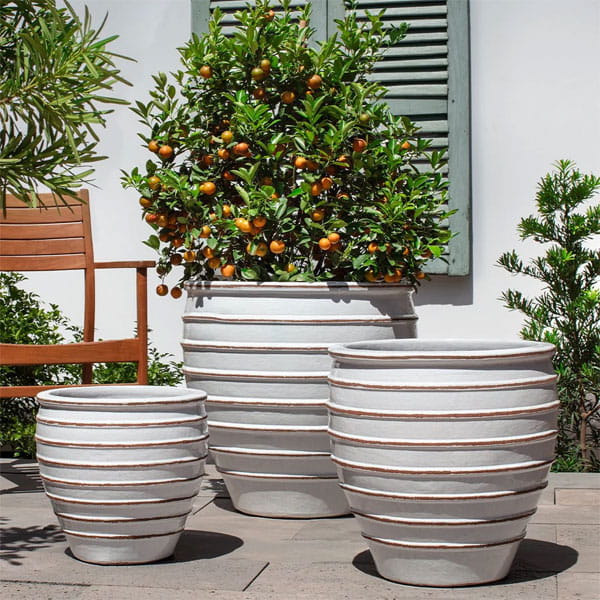 Vari Planter Set of 3 in Antique White on concrete in the backyard.