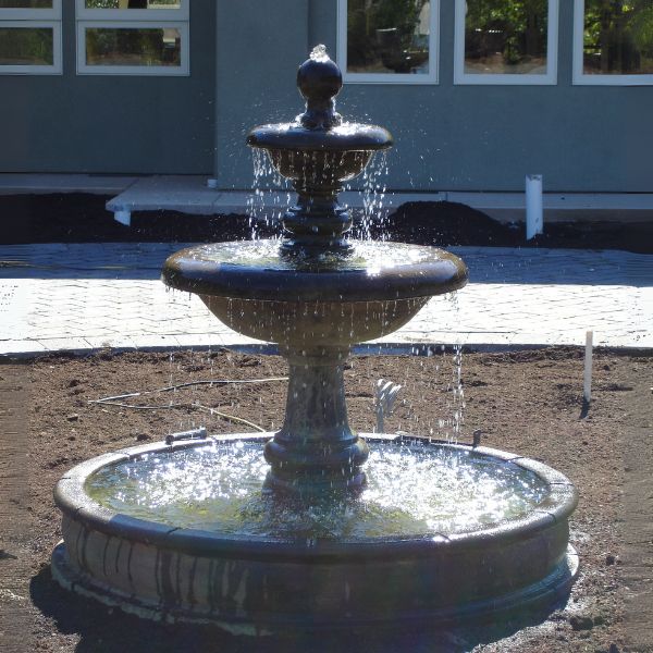 Villa Santini Two Tier Pond Fountain, Tall in action in front of the house.