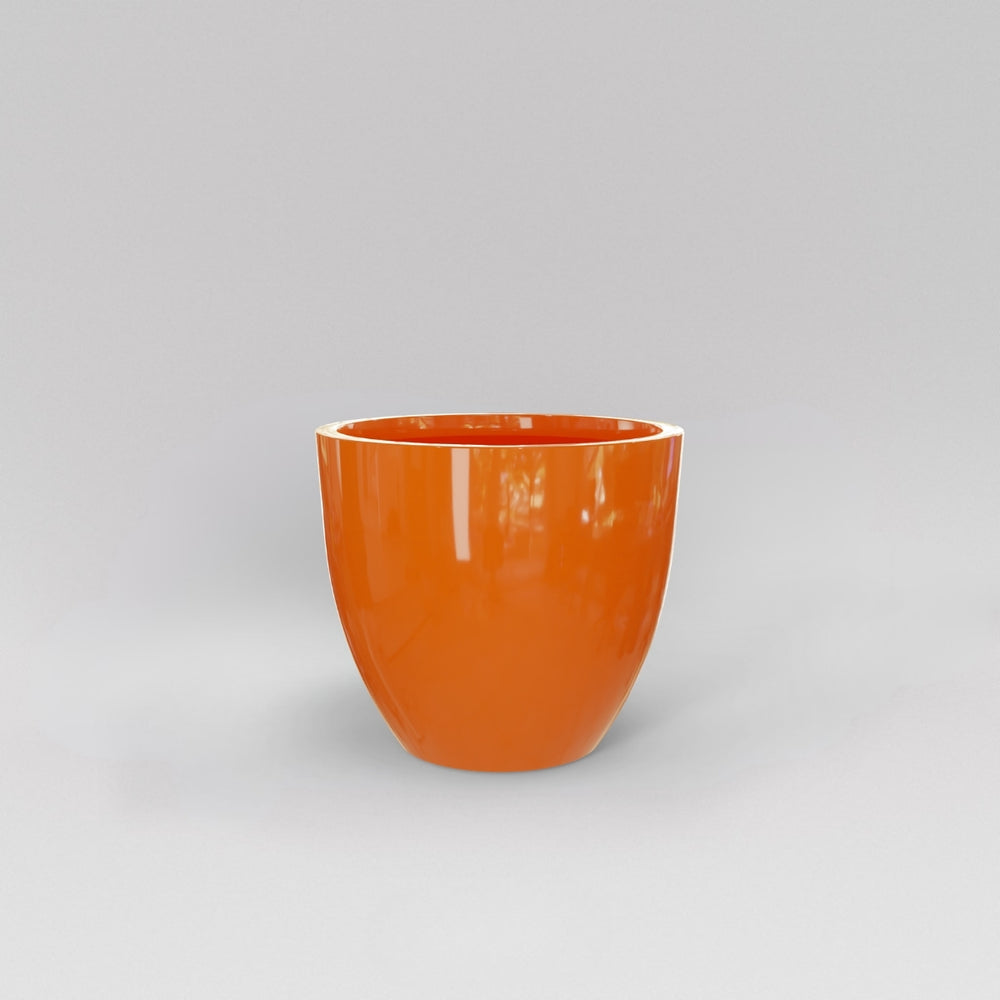 Wannsee Extra Large Round Fiberglass Planter in gloss tangerine against gray background.