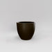 Wannsee Extra Large Round Fiberglass Planter in matte bronze against gray background.