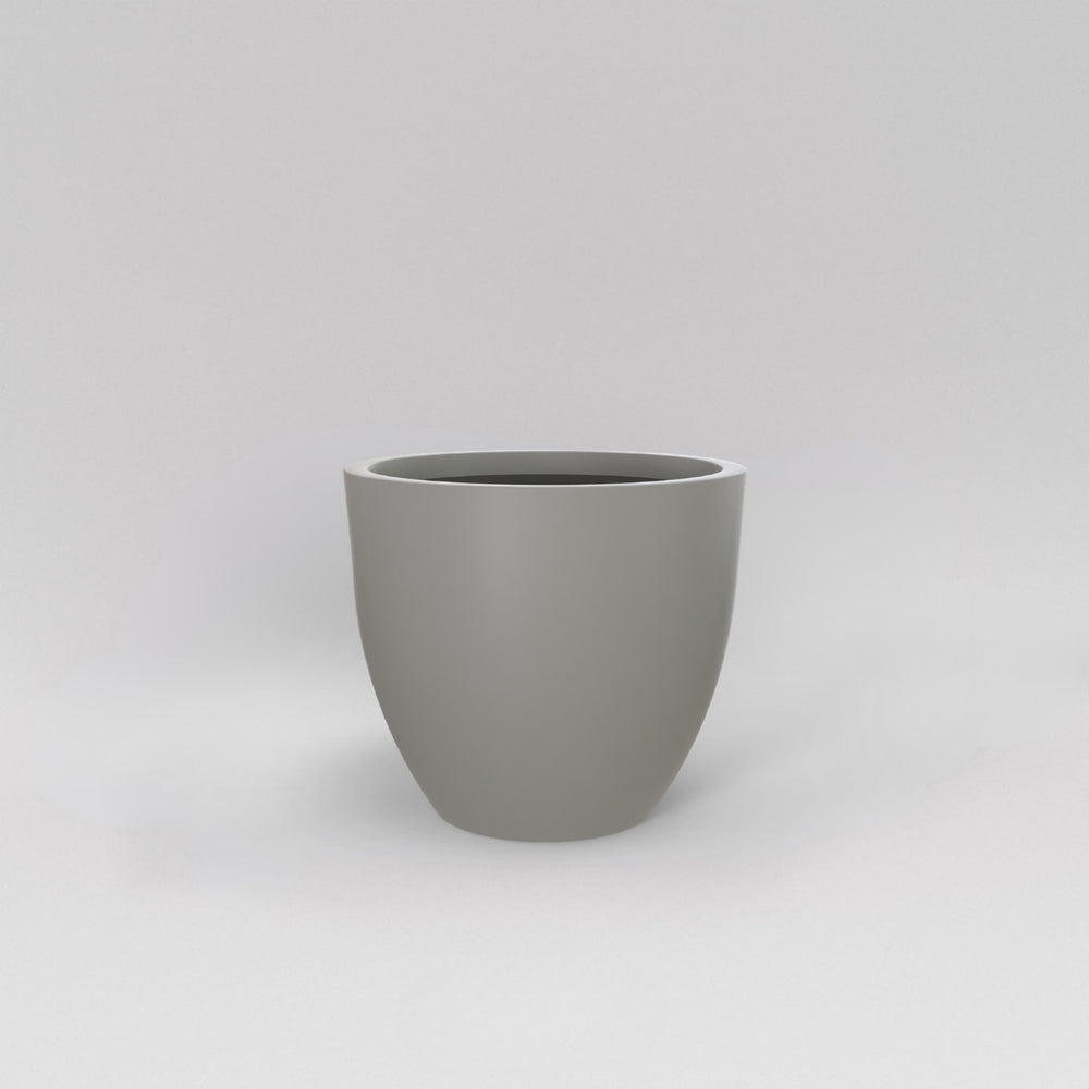Wannsee Extra Large Round Fiberglass Planter in matte cement grey against gray background.