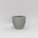 Wannsee Extra Large Round Fiberglass Planter in matte cement grey against gray background.