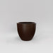 Wannsee Extra Large Round Fiberglass Planter in matte dark brown against gray background.