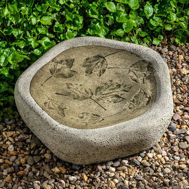 Woodland Leaves Birdbath on pebbles in the backyard.