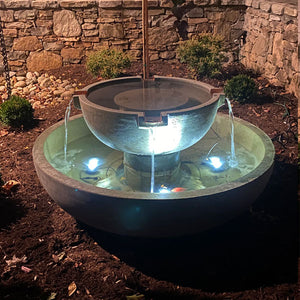 3 led lights shining from large fountain bottom bowl