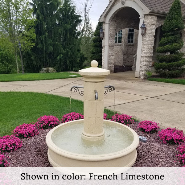 Campania Avignon Fountain in front of house surrounded by pink flowers in action