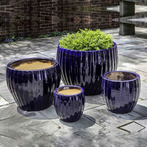 Andromeda Planter-Sapphire - Set of 4 on concrete floor in the backyard
