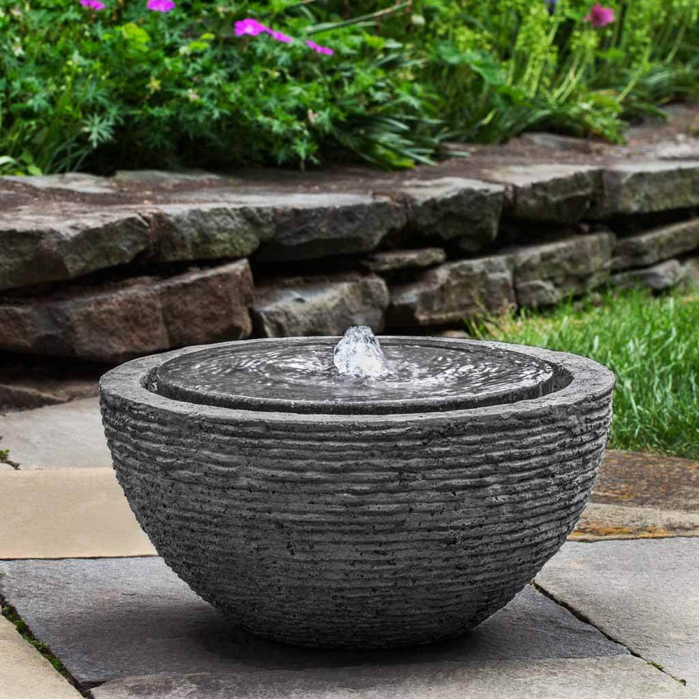 Arroyo Fountain Stone Ledge in action on concrete patio in backyard