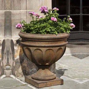 Augusta Urn on stone filled with pink flowers