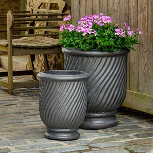 Beausoleil Planter Graphite S/3 on concrete filled with pink flowers