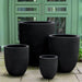 Bradford Planter, Medium - Onyx Black Lite - S/1 on concrete against green door