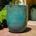 Brantome Planter Weathered Copper S/3 on bricks in backyard