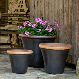 Brighton Planter - Graphite Set of 3 filled with pink flowers beside a chair