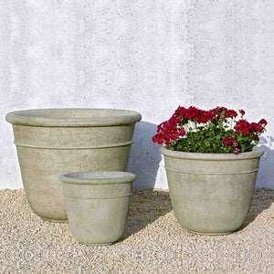 Carema Small Planter with two smaller planters on gravel near white wall