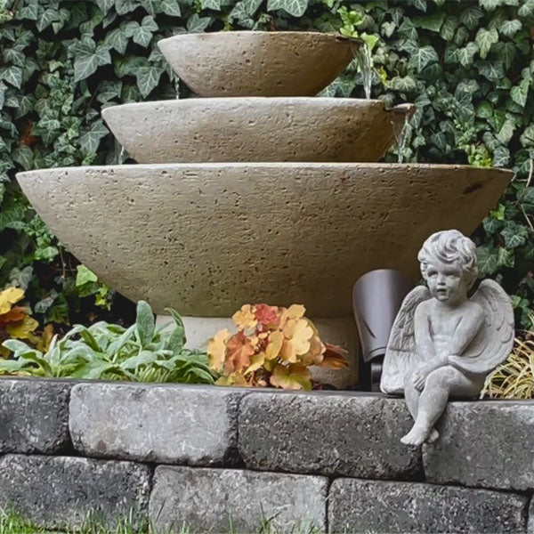 Carrera Oval Fountain running with green ivy backdrop