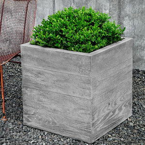 Chenes Brut Large Box Planter on gravel filled with plants