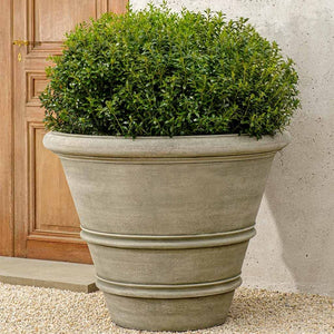Classic Rolled Rim 40 Planter filled with plants near door