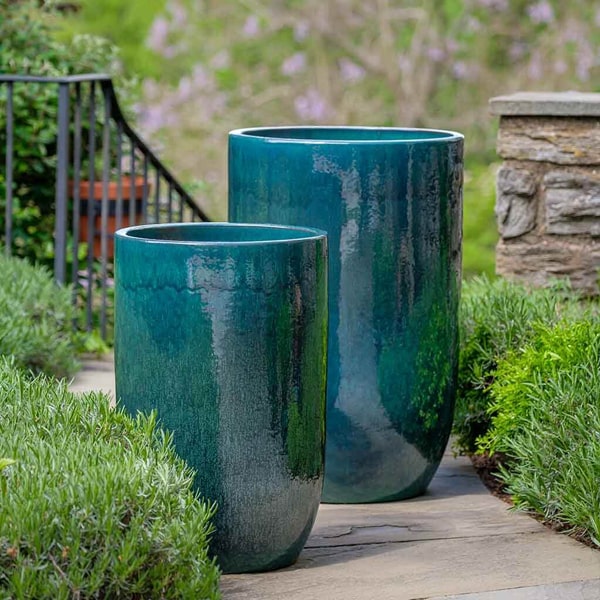 Cole Planter - Indigo Rain - S/2 beside green plants in the backyard