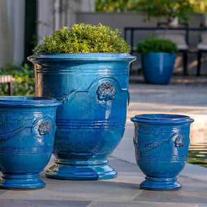 Coquille Anduze Urn S/3 Cerulean Blue filled with plants in the backyard