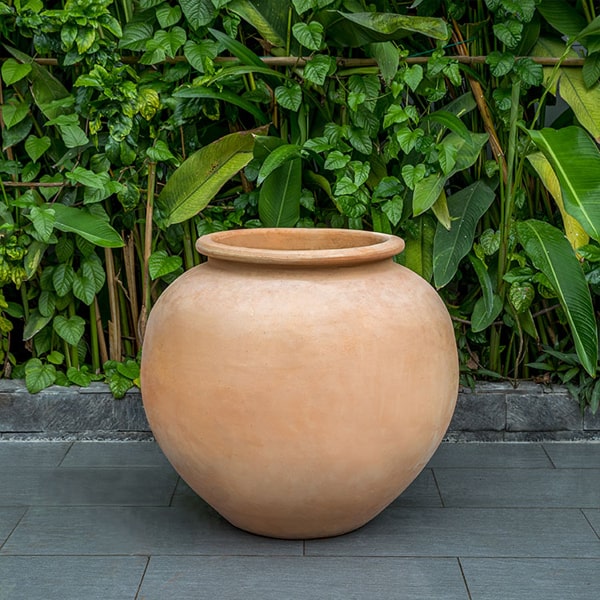 De Vesian Jar Planter - Terra Cotta - S/1 on concrete against green plants