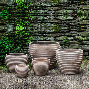 Elia Planter - Antico Terrra Cotta - S/5 on gravel against wall with plants