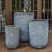 Escada Tall Planter Verdigris S/3 against glass door on patio