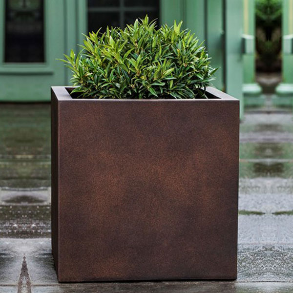 Farnley Planter 2424 - Rust Lite S/1 on concrete filled with plants