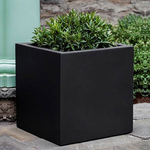Farnley Planter 2828 - Onyx Black Lite S/1 on concrete filled with plants