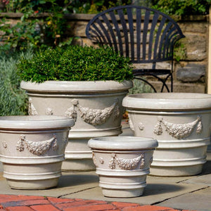 Garland Rolled Rim Planter - Antique White - S/4 filled with plants in the backyard