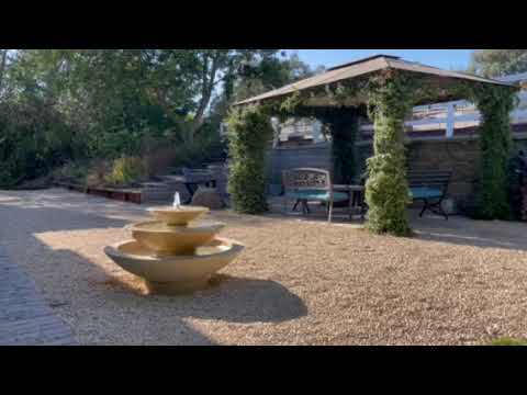 Cascade fountain in action in front of gazebo