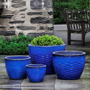 Hyphen Planter - Riviera Blue - S/4 filled with plants in the backyard
