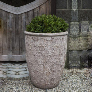 Jacquard Tall Planter - Antico Terra Cotta S/3 filled with plants in the backyard