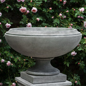 Jensen Urn, Large against pink flowers with green leaves upclose