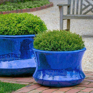 Jura Planter Riviera Blue S/2 filled with plants in backyard
