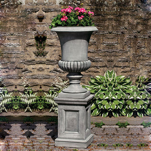 Kent Urn filled with plants against concrete wall