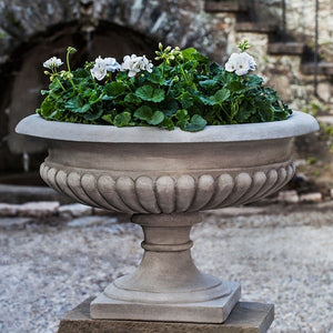 Kingscote Urn filled with flowers in the backyard