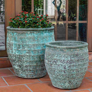 Knossos Planter Verdigris S/2 filled with plants on patio