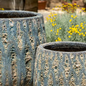 Lambrate Planter Aqua Blue Coral S/3 near yellow flowers in the backyard upclose
