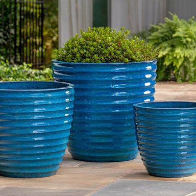 Linea Planter Cerulean Blue S/3 filled with plans in the backyard