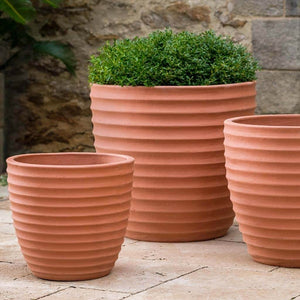 Linea Planter Terra Rosa S/3 filled with plans in the backyard