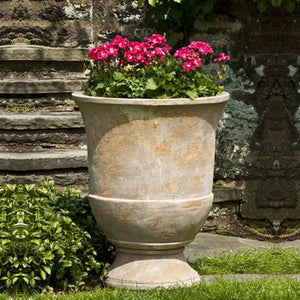 Lipari Urn S/2 Antico Terra Cotta filled with red flowers in the backyard