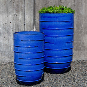 Logis Planter, Tall - Riviera Blue - S/2 on gravel filled with plants