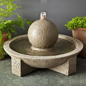M-Series Sphere Fountain on concrete beside green plants