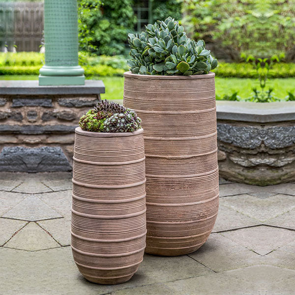 https://theblissfulplace.com/cdn/shop/products/madera-tall-planter-antico-terra-cotta-s-2-filled-with-plants-in-backyard.jpg?v=1669173370